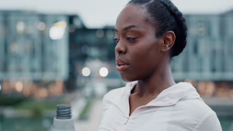 City.-fitness-and-black-woman-drinking-water