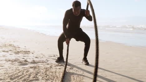 Black-man,-fitness-and-battle-rope-on-beach