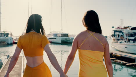 Back,-happy-and-women-holding-hands-at-the-sea