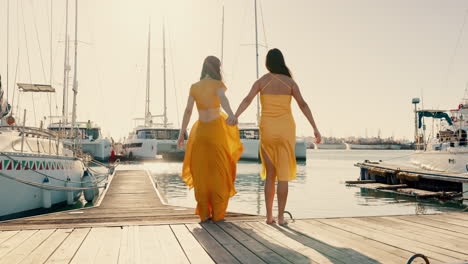 Back,-happy-and-women-holding-hands-at-a-harbor