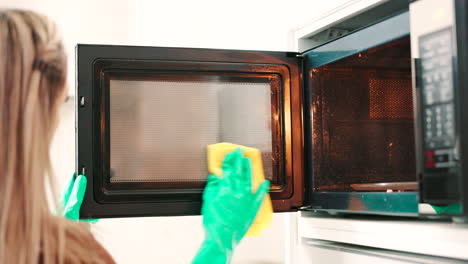 Cloth,-person-hands-and-cleaning-microwave-door
