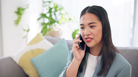 Phone-call,-happy-and-Asian-woman-talking-on-sofa
