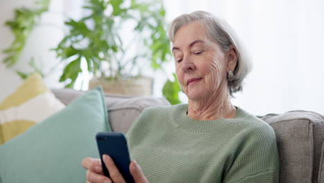 Phone,-relax-and-senior-woman-on-a-sofa-browsing