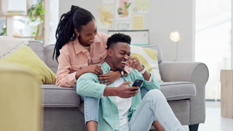Home,-relax-and-black-couple-with-a-smartphone