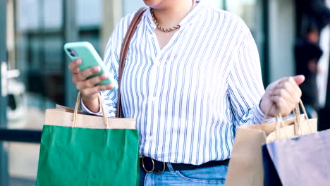 Woman,-phone-and-hands-walking-with-shopping-bag