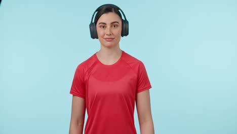 Fitness,-headphones-and-watch-of-a-woman-in-studio