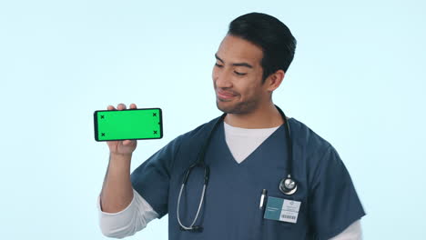 Happy-man,-doctor-and-pointing-to-phone-on-green