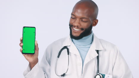 Green-screen,-phone-and-face-of-doctor-in-studio