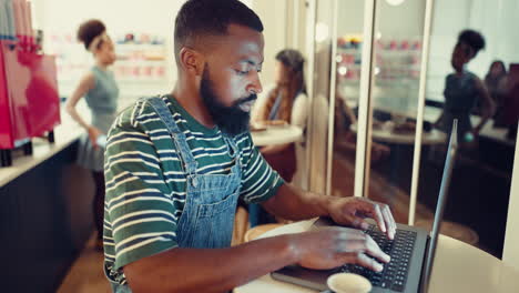 Cafe,-creative-and-black-man-with-a-laptop
