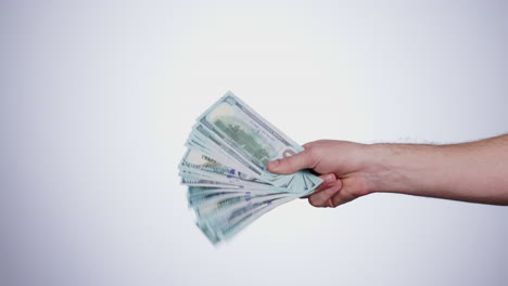 Hand,-payment-and-closeup-of-cash-in-a-studio