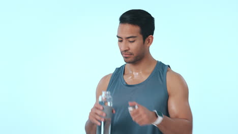 Man,-drinking-water-and-workout-in-studio