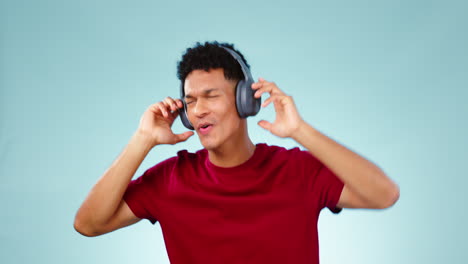 Happy-man,-headphones-and-dancing-studio