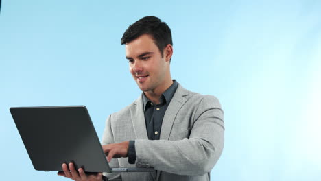Laptop,-smile-and-businessman-typing-in-studio