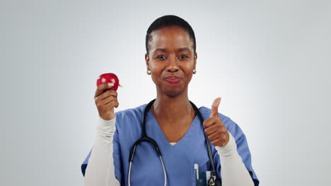 Thumbs-up,-apple-and-black-woman-doctor-eating