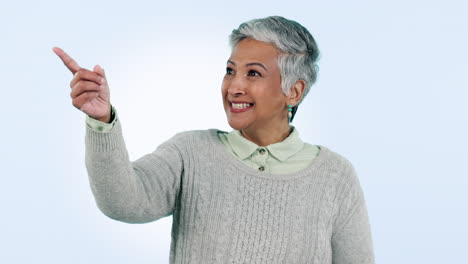 Happy,-face-and-senior-woman-with-hand-pointing