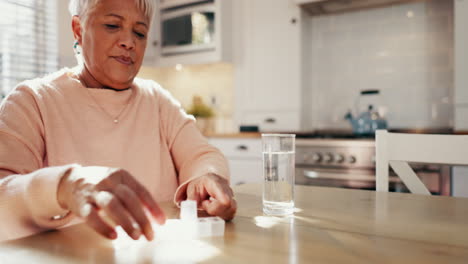 Old-woman-with-pills-in-kitchen