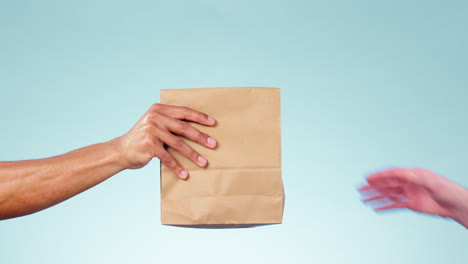 Hands,-giving-bag-and-studio-closeup-for-delivery