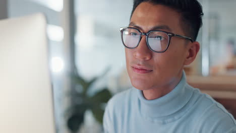 Asian-man-at-computer,-glasses-and-reflection
