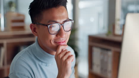 Asian-man-at-computer,-glasses-and-ideas