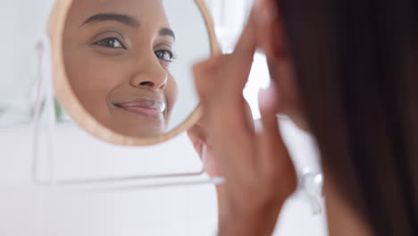 Mirror,-skincare-and-young-woman-in-her-bathroom