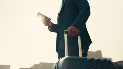 Man,-suitcase-and-phone-with-watch
