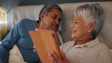 Love,-kiss-and-senior-couple-in-a-bed-with-tablet