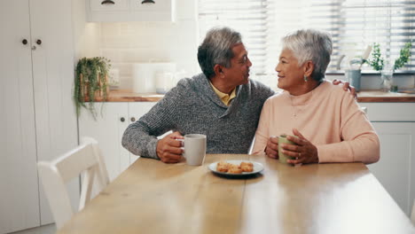 Senior-couple,-kiss-and-bonding-in-kitchen
