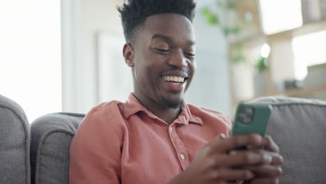 Relax,-laugh-and-black-man-on-sofa-with-phone