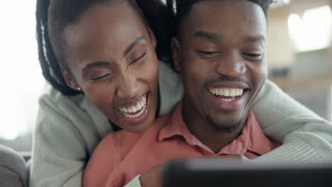 Happy,-hug-and-couple-with-tablet-in-a-living-room