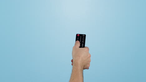 Hand,-remote-and-changing-channels-on-tv