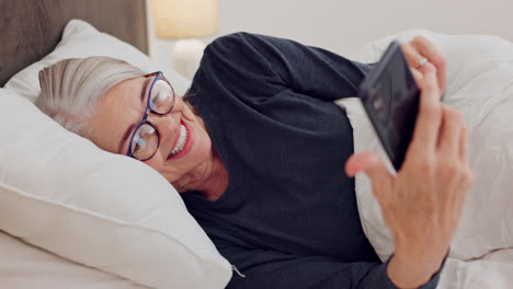Phone,-laughing-and-senior-woman-in-bed-watching