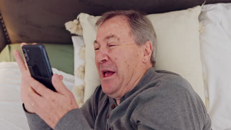 Phone,-laughing-and-senior-man-in-bed-watching