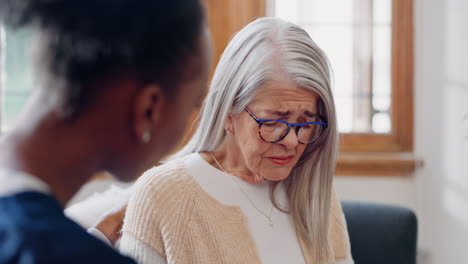 Senior,-sad-woman-speaking-or-nurse-with-support