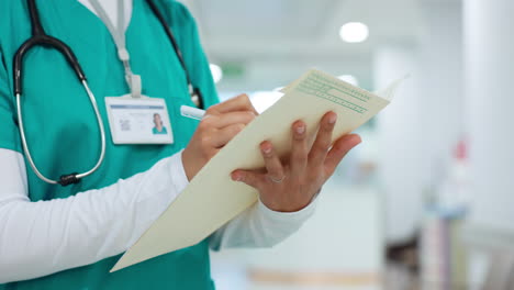 Nurse,-writing-and-hands-on-folder-in-hospital