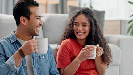 Coffee,-happy-and-couple-on-sofa-in-living-room