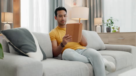 Man,-sofa-and-tablet-for-home-video-streaming