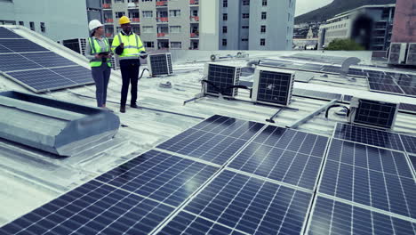 Teamwork,-drone-and-solar-engineers-on-roof