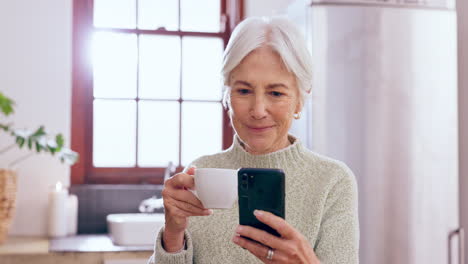 Senior,-woman-and-phone-with-coffee-in-kitchen