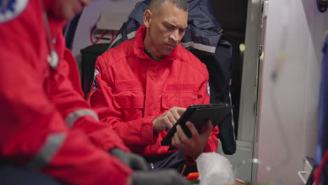 Talking,-man-and-a-tablet-for-ambulance-emergency