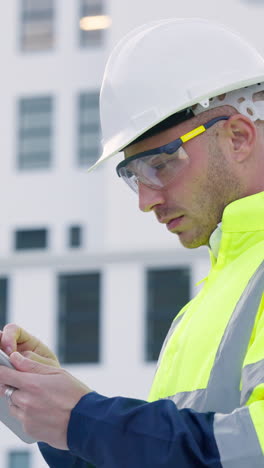 Construction,-man-and-tablet-at-building-in-city