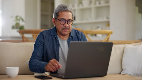 Senior-man,-home-or-thinking-with-laptop