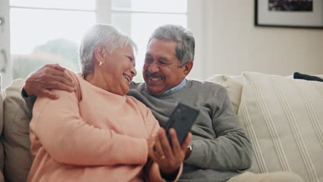 Phone,-smile-and-senior-couple-on-sofa-in-home