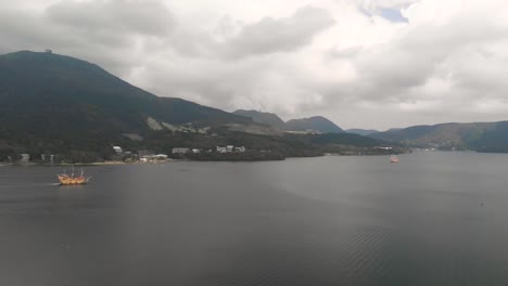 Vista-Aérea-Del-Barco-Pirata-Naranja-En-El-Lago-Ashi-En-Hakone-En-Un-Día-Nublado