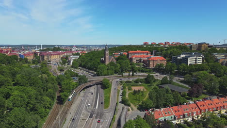 Aerial-View-Of-The-Slottskogen-Towards-Downtown-With-Green-Trees-and-Unique-Buildings-During-Sunny-Day---Aerial-Shot