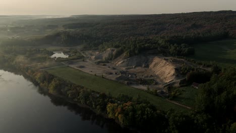 Quarry-Site-Surrounded-By-The-Abundant-Forest-Near-The-Saint-Francois-River-In-Windsor-On-A-Hazy-Morning-In-Quebec,-Canada