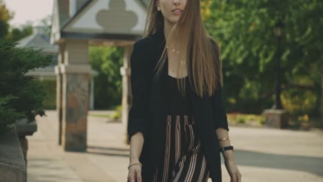 Beautiful-Young-Female-Model-In-Casual-Black-Outfit-Turning-Back-Walking-Towards-The-Camera---Slow-Motion