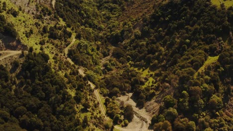 Hills-and-forest-drone-footage-with-roads-going-up-hill