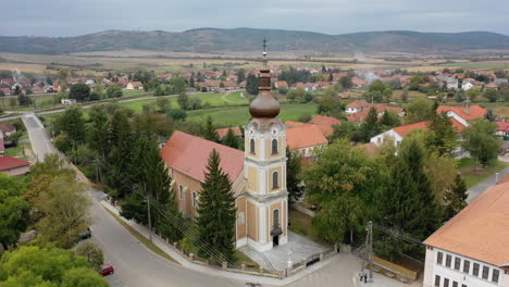 Moving-aerial-view-village-Hungary-Szendrő-church