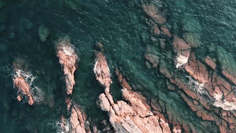 Waves-of-the-Coast-of-Genoa-splashing-on-the-rocky-shoreline--aerial