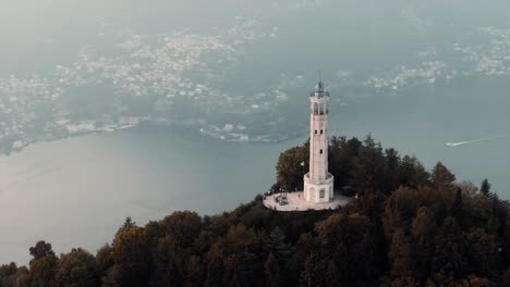 Volta-Lighthouse-On-The-Hilltop-Overlooking-The-Como-Lake-And-City-On-A-Misty-Morning-In-Brunate,-Italy,-Europe